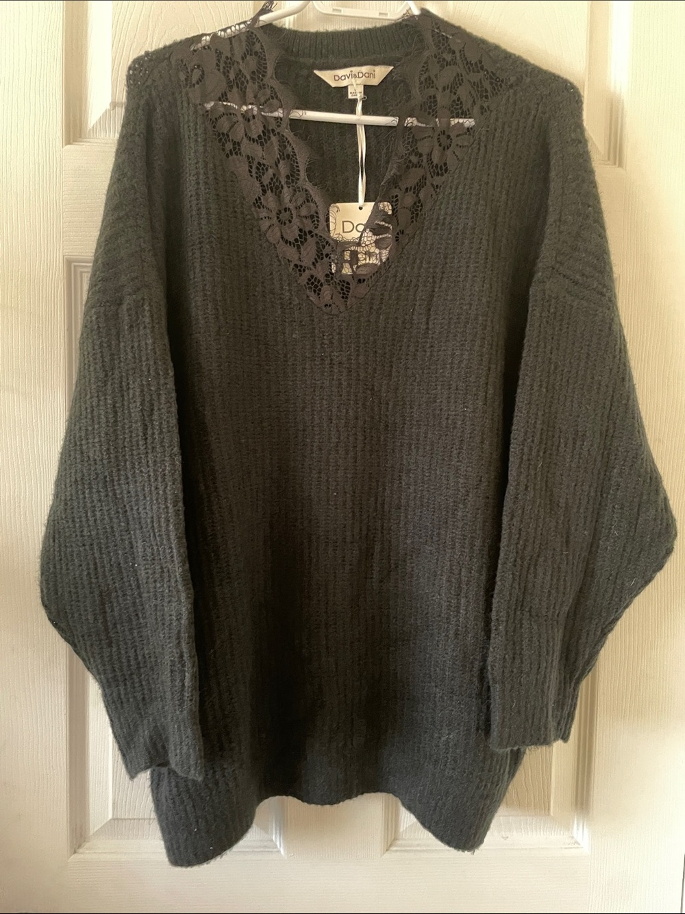 Soft oversized black sweater with eyelash lace neckline